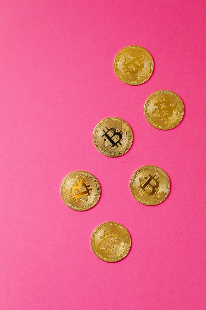 why-choose-us-03 Gold Bitcoin coins arranged on a striking pink background, showcasing cryptocurrency appeal.