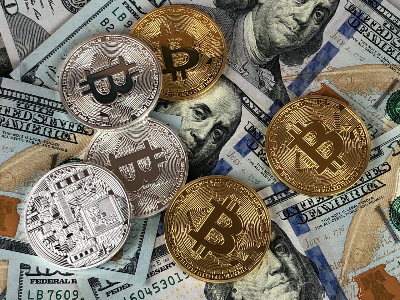 hero-02 Close-up of bitcoins and US dollar bills symbolizing modern finance and cryptocurrency.